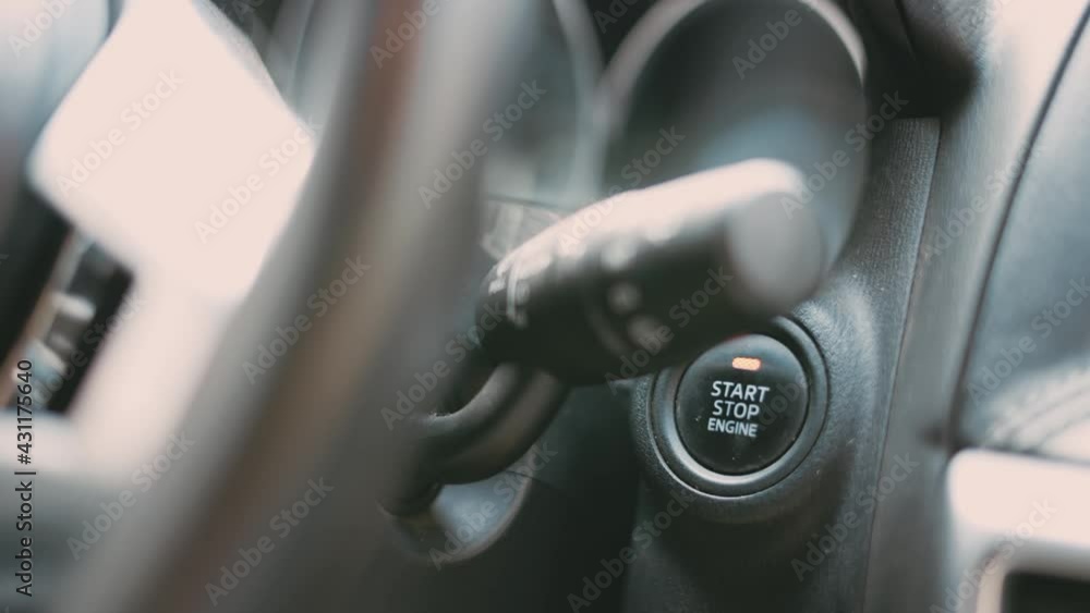 Finger pushing power ignition button on keyless automobile Finger pushing power ignition button on keyless automobile