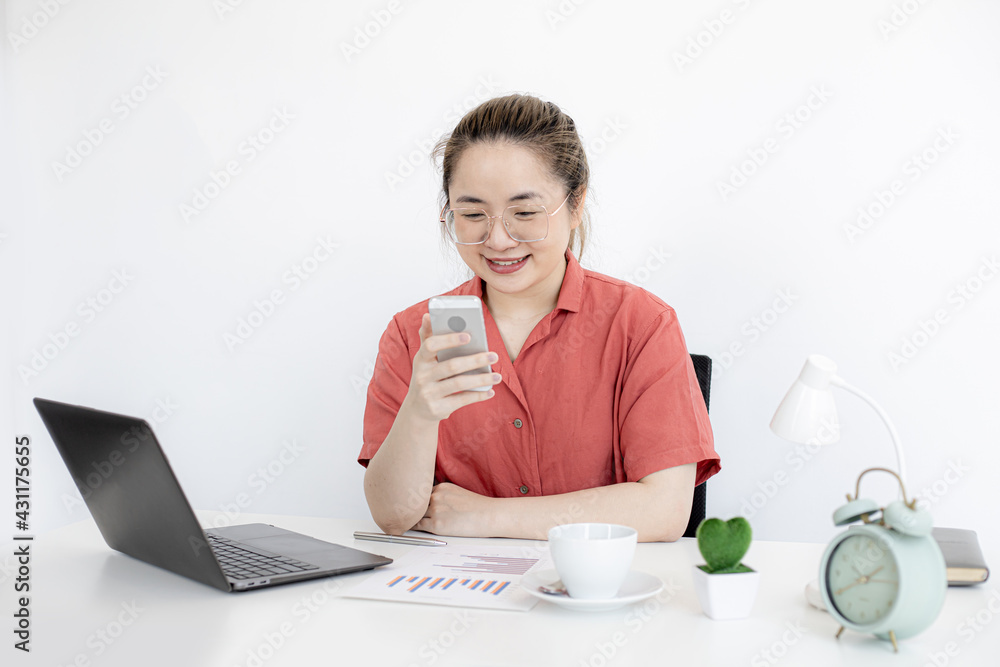 A business woman is holding a smartphone, texting to a business partner in a messenger. The concept of using smartphone technology in business communication with partners. A business woman is holding a smartphone, texting to a business partner in a messenger. The concept of using smartphone technology in business communication with partners.