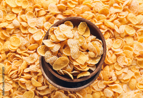 Golden corn flakes in woode...