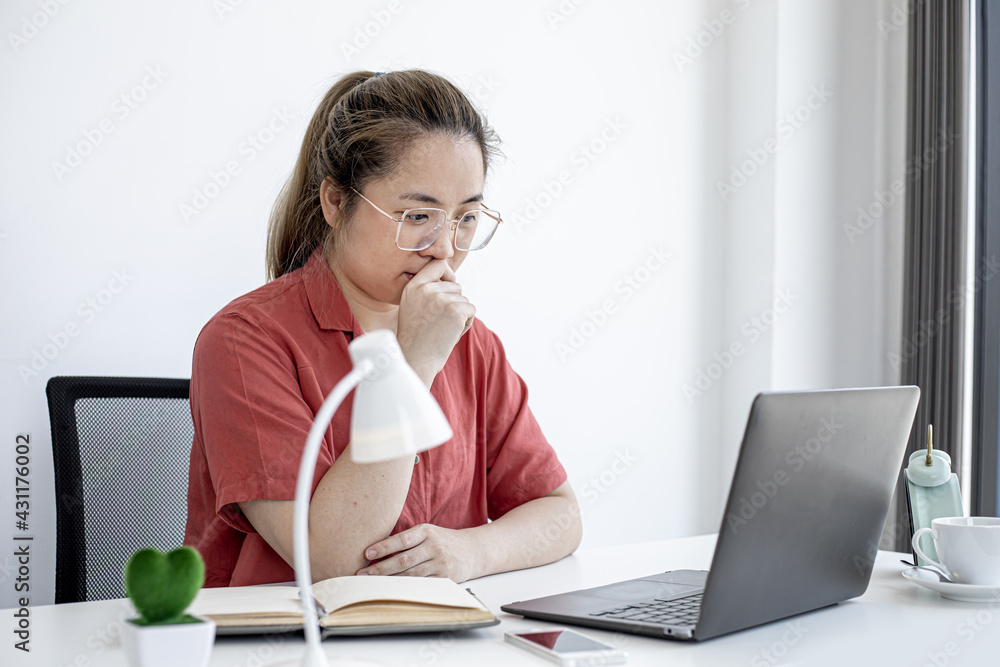 A business woman thinks about work in her office, working from home to prevent the spread of COVID-19, she is having a serious meeting with a partner. The idea of working from home. A business woman thinks about work in her office, working from home to prevent the spread of COVID-19, she is having a serious meeting with a partner. The idea of working from home.