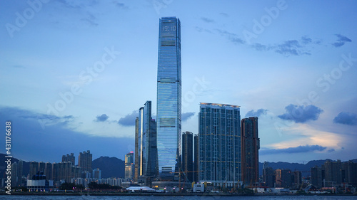 Hong Kong - June 25, 2016: city skyline view in Hong Kong at sunset, IFC building, blue sky, modern architecture, illustrative editorial
