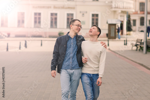 Young gay couple smiling happy and hugging at the city. © Ivan Zelenin