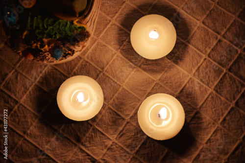 Top view of romantic tealights, candles in a dim floor