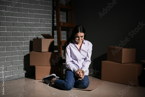 Female hostage in dark room