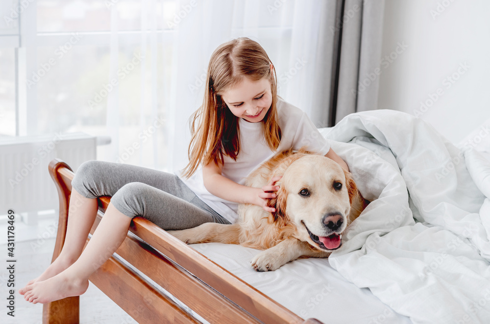 Girl with golden retriever dog in the bed Girl with golden retriever dog in the bed
