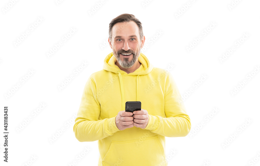 senior guy texting and messaging on smartphone isolated on white. guy in yellow hoody check email. senior guy texting and messaging on smartphone isolated on white. guy in yellow hoody check email.