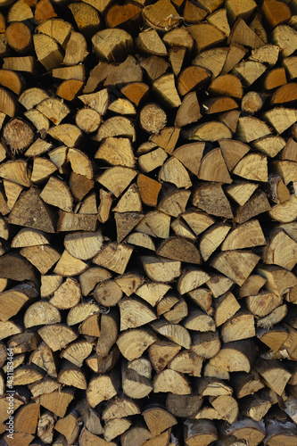 Stacked chopped firewood. Vertical orientation.