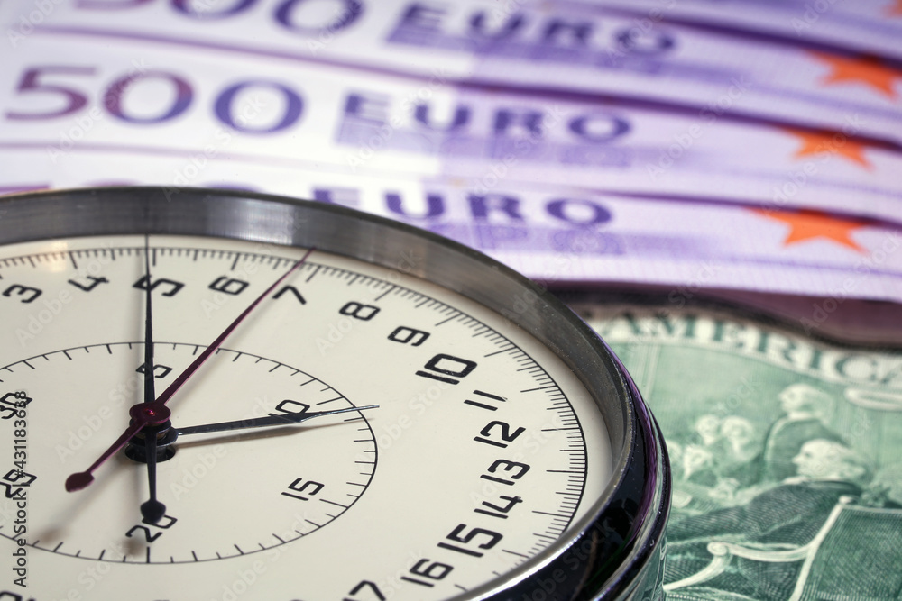 Money macro shot. The stopwatch lies in the center of the banknote layer. Clock. Time is money Money macro shot. The stopwatch lies in the center of the banknote layer. Clock. Time is money