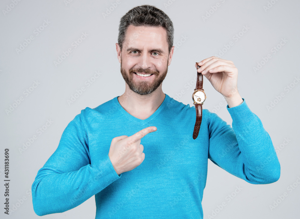 happy handsome mature man with beard pointing finger on wristwatch, fashion accessory happy handsome mature man with beard pointing finger on wristwatch, fashion accessory