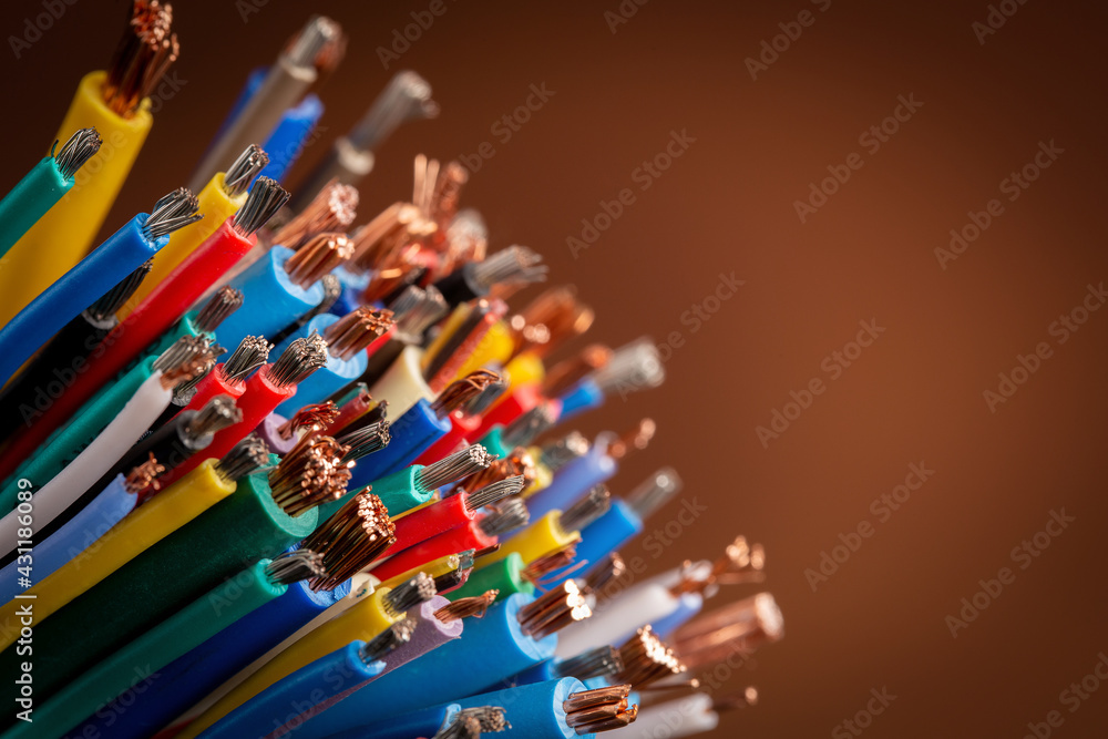 Obraz premium Close-up of colored electrical cable on brown with copy space, background