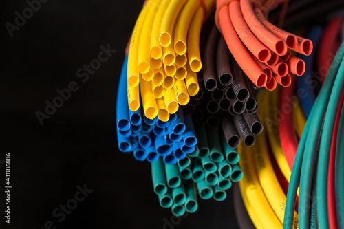 Close-up of colorful shrink tube with black background, used in general electrical