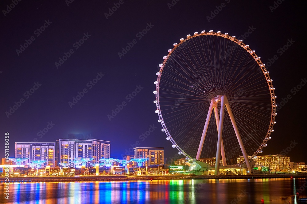 Ferris wheel stands on the beach of Dubai