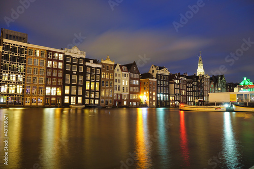 Amsterdam dancing houses on Damrak illuminated lit up at night houses with dutch architecture by the canal Amsterdam Netherlands