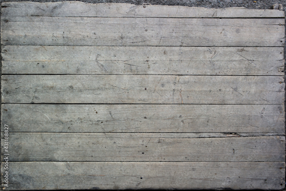 Texture of old rough unpainted planks on the old wooden pallet surface with nails Texture of old rough unpainted planks on the old wooden pallet surface with nails