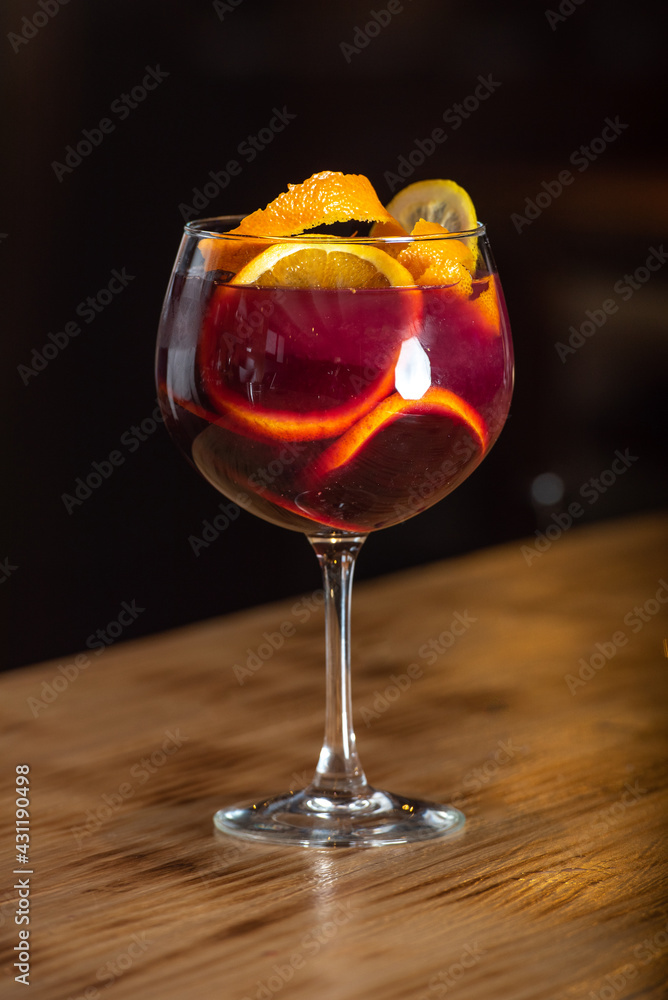 Sangria drink in glass isolated on a wooden table.
