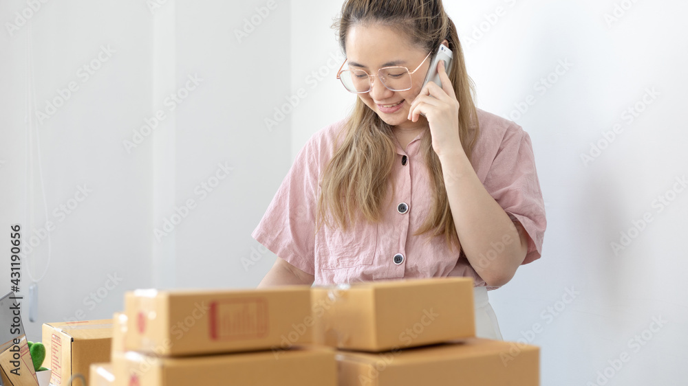 Young woman selling products online was talking on the phone to receive an order from a customer who called and wrote down the list in a notebook, New kind of business for young, Sell online. Young woman selling products online was talking on the phone to receive an order from a customer who called and wrote down the list in a notebook, New kind of business for young, Sell online.