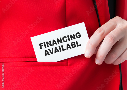 Fiinancing Available words on card in businessman hand that he puts in his red jacket pocket, business concept.