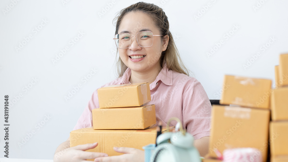 Young woman was happy after receiving an order from an internet customer, New business style for young people working at home and owning businesses, Sell online or Online sell concept. Young woman was happy after receiving an order from an internet customer, New business style for young people working at home and owning businesses, Sell online or Online sell concept.