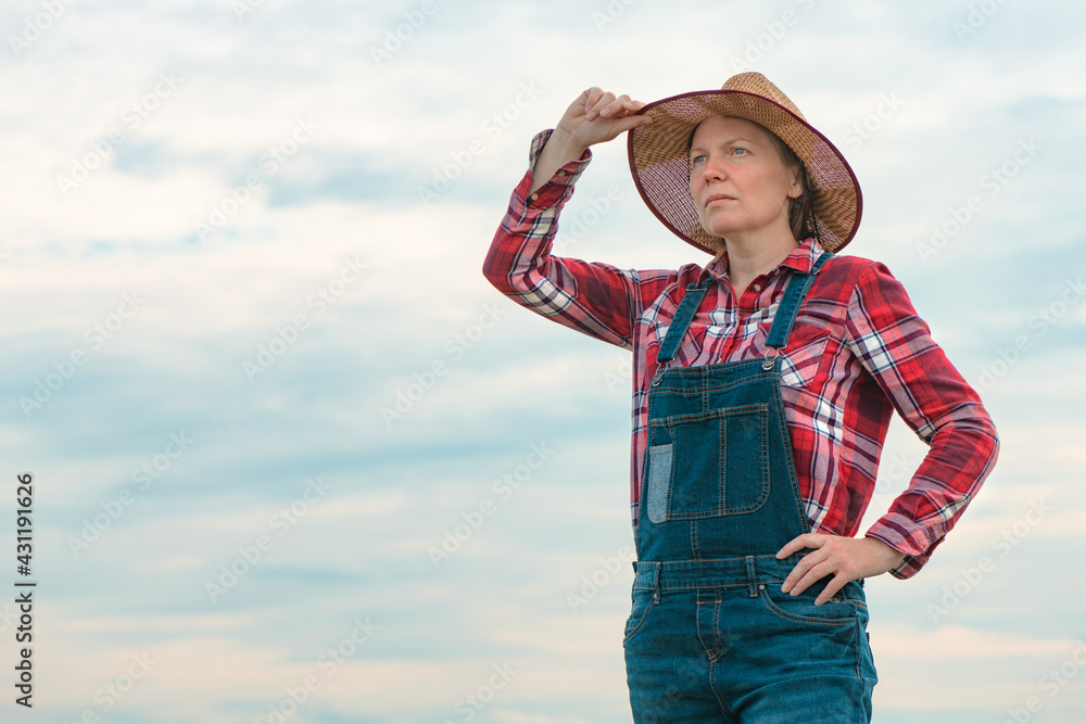 Portrait of concerned female farmer agronomist outdoors
