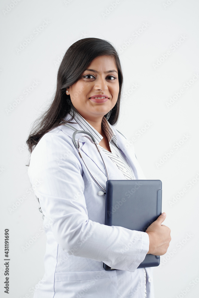 Portrait of young smiling female doctor in labcoat holding tablet computer and looking at camera Portrait of young smiling female doctor in labcoat holding tablet computer and looking at camera