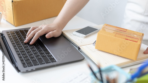 Young woman uses a laptop to chat with customers who come to order product, New young businesses that can work from home and deliver their goods by post, Sell online or Online sell.