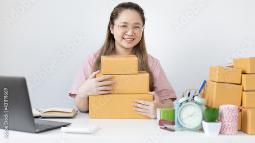 Young woman was happy after receiving an order from an internet customer, New business style for young people working at home and owning businesses, Sell online or Online sell concept.