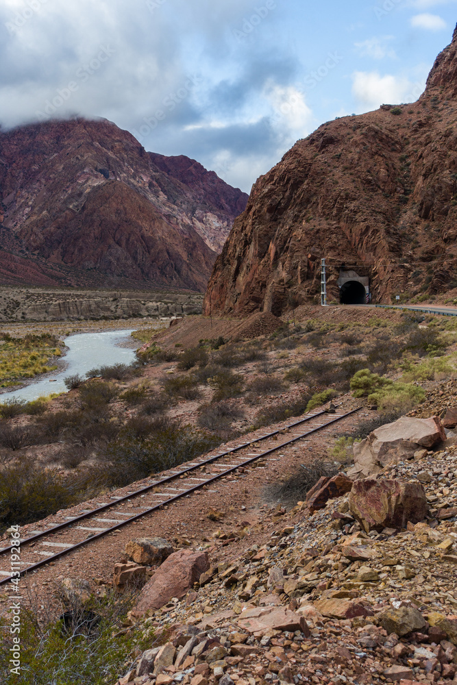 Old train rails, a mountain river and a tunel.