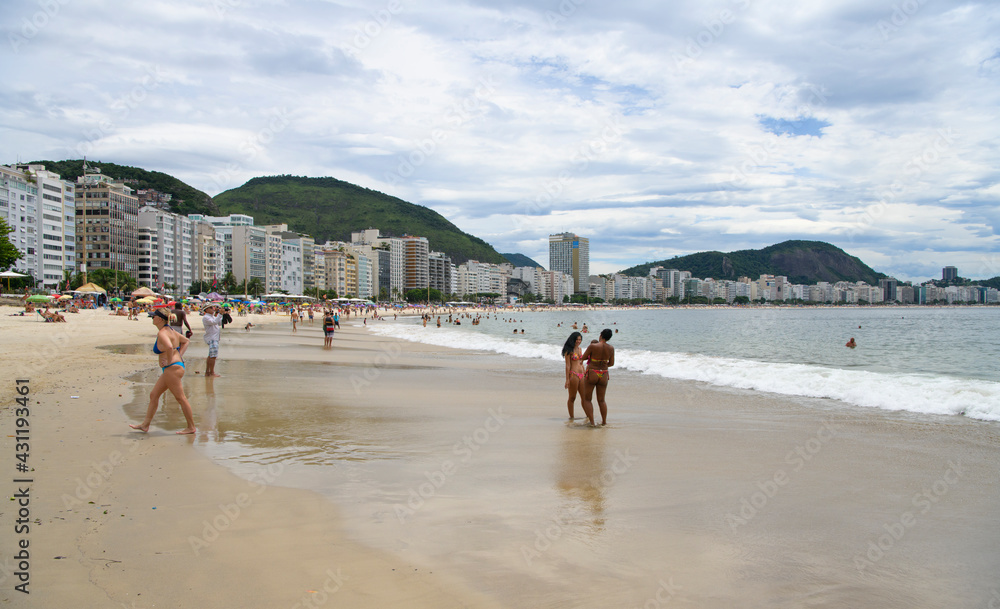   Citizens swim and sunbathe on the beach of Copacabana