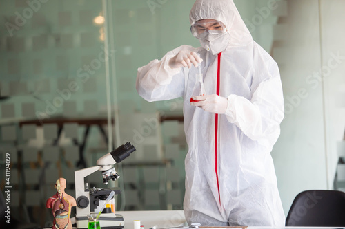 The doctor is testing a sample of biological tubes contaminated by Corona-virus Covid 19 and searching for a vaccine or Syrup against the virus. In the laboratory and film samples of infected lung