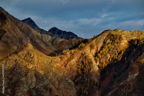 Russia. Mountain Altai. Expressive graphics of autumn sunlight on the rocks of mountain ranges.