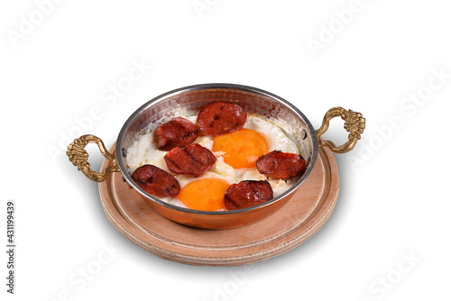 Turkish breakfast with eggs in a copper pan. Eggs with sausage in copper pan, white background close up. traditional turkish breakfast. (Turkish Sosis) photo