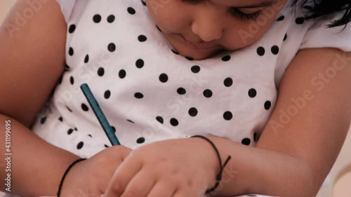 Little girl studying or writing at home