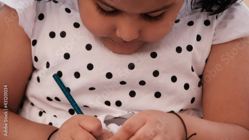 Little girl studying or writing at home