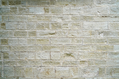 Stone wall bricked with strong structure  photographed in daylight