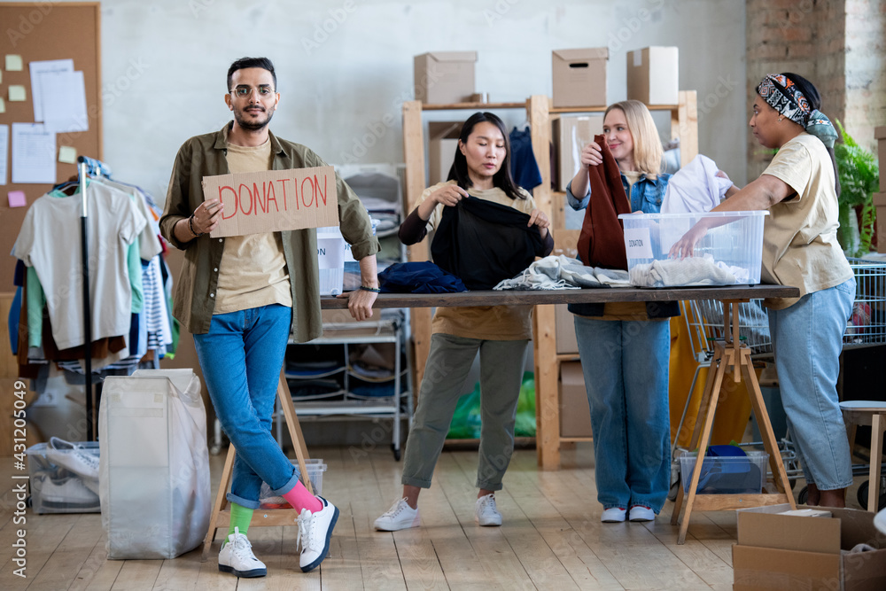 A group of volunteers preparing donation in a room A group of volunteers preparing donation in a room