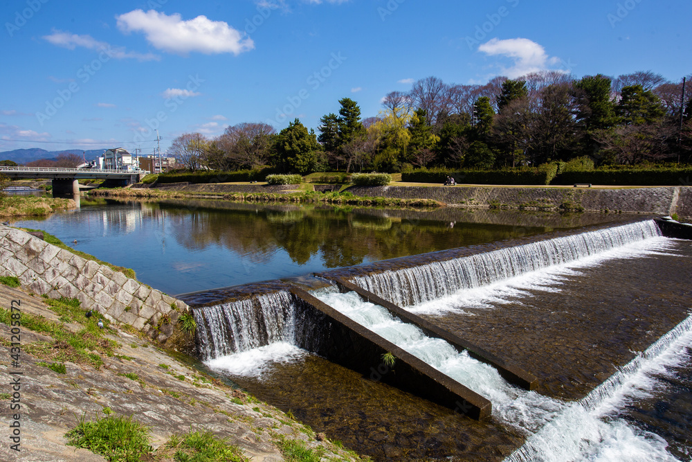Artificial rapids on the river  Kamo - idyllic landscape in sunny day  in Kyoto!  Park Kamogawa. 