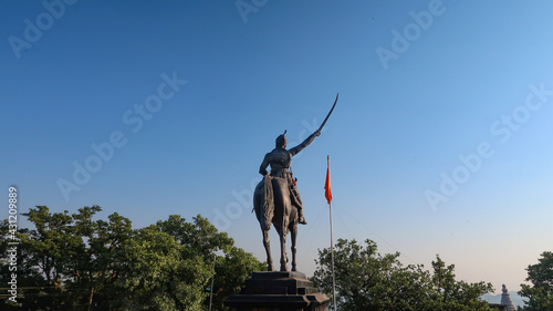 Statue of Chhatrapati Shivaji Maharaj on horseback riding a horse with raised sword Pratapgad, Maharashtra, India photo