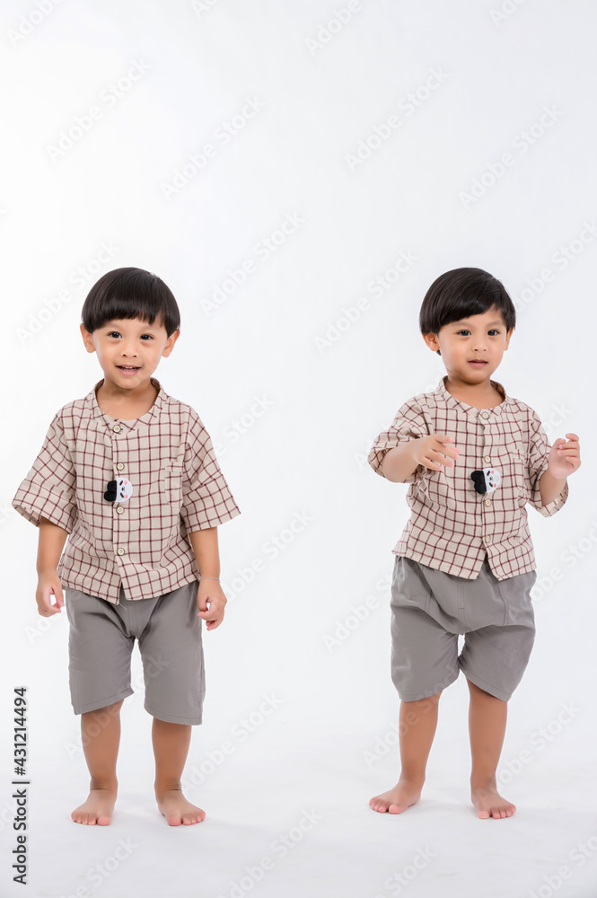 Studio portrait of twins children on a white background. Funny couple of identical brothers on a white background. Twins baby boy. Studio portrait of twins children on a white background. Funny couple of identical brothers on a white background. Twins baby boy.
