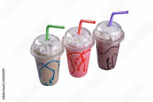 Strawberry, chocolate and caramel milkshakes in plastic cup on white background. menu photos