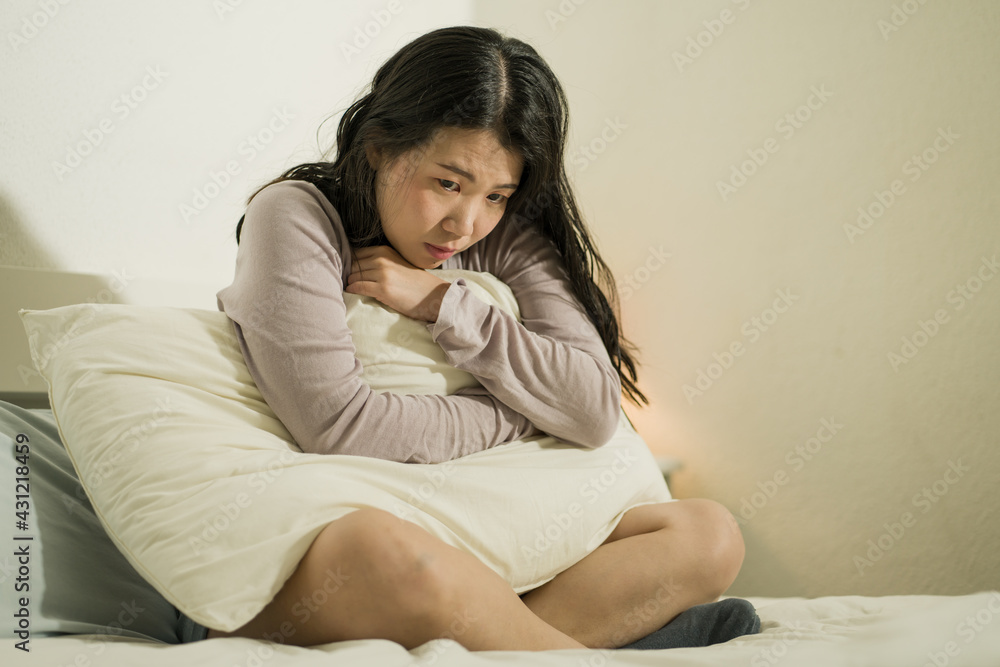 young Asian woman depressed - young beautiful and sad Chinese girl on bed with pillow feeling unhappy and broken heart suffering depression problem at home bedroom young Asian woman depressed - young beautiful and sad Chinese girl on bed with pillow feeling unhappy and broken heart suffering depression problem at home bedroom