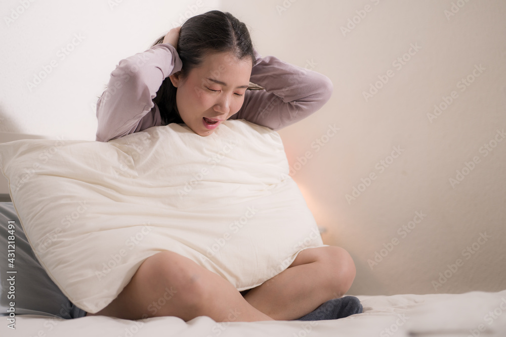 young Asian woman depressed - young beautiful and sad Chinese girl on bed with pillow feeling unhappy and broken heart suffering depression problem at home bedroom young Asian woman depressed - young beautiful and sad Chinese girl on bed with pillow feeling unhappy and broken heart suffering depression problem at home bedroom