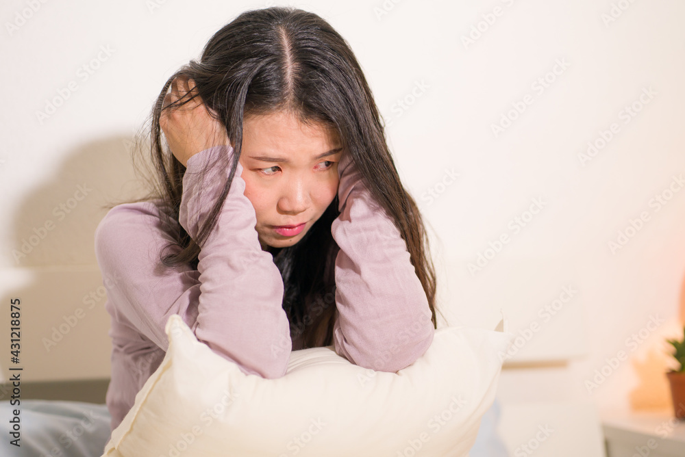 young Asian woman depressed - young beautiful and sad Korean girl on bed with pillow feeling unhappy and broken heart suffering depression problem at home bedroom young Asian woman depressed - young beautiful and sad Korean girl on bed with pillow feeling unhappy and broken heart suffering depression problem at home bedroom