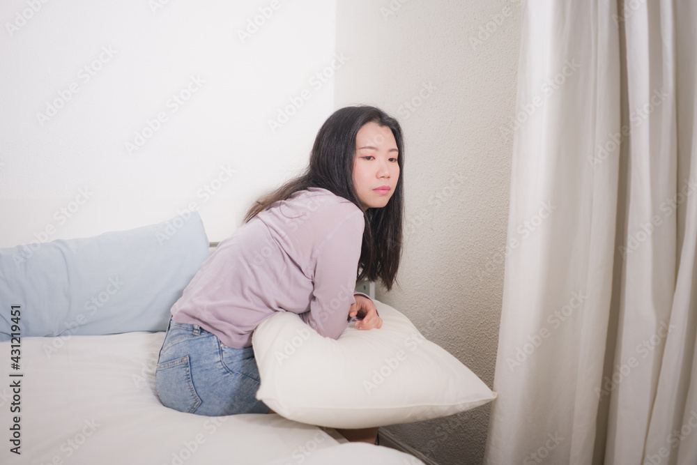 young Asian woman depressed - young beautiful and sad Japanese girl on bed with pillow feeling unhappy and broken heart suffering depression problem at home bedroom young Asian woman depressed - young beautiful and sad Japanese girl on bed with pillow feeling unhappy and broken heart suffering depression problem at home bedroom