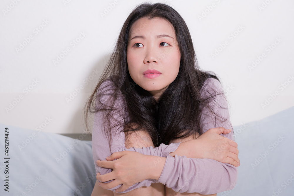 young Asian woman depressed - young beautiful and sad Japanese girl on bed with pillow feeling unhappy and broken heart suffering depression problem at home bedroom young Asian woman depressed - young beautiful and sad Japanese girl on bed with pillow feeling unhappy and broken heart suffering depression problem at home bedroom