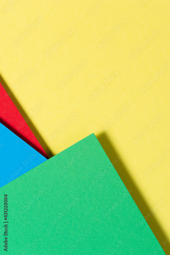 Abstract color papers geometry flat lay composition background with blue, yellow, red and green color tones Abstract color papers geometry flat lay composition background with blue, yellow, red and green color tones