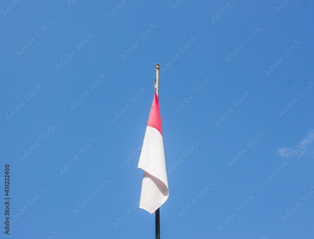 
Indonesian national flag flying in the bright sky.