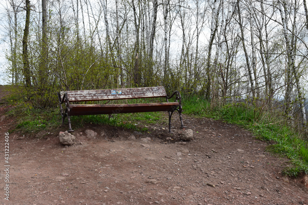 Abandoned wooden bench at the top of tailings heap Abandoned wooden bench at the top of tailings heap