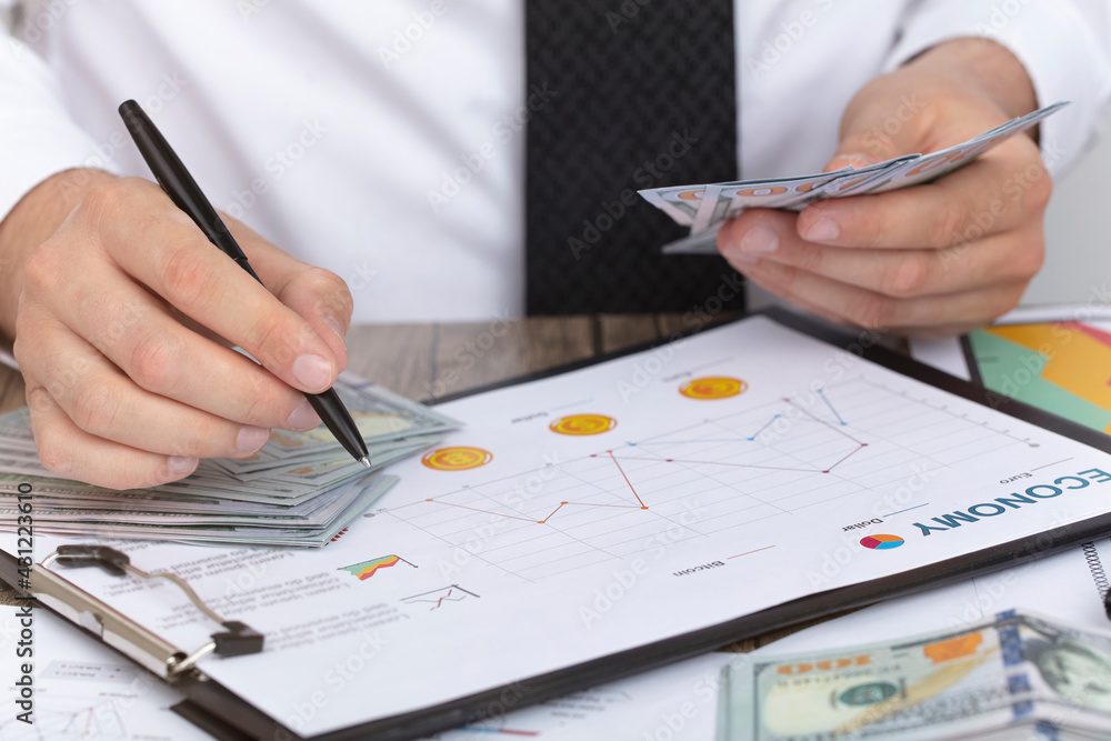 Business accounting concept. Counting Money Pile. economy concept, businessman background.
Business accounting concept. Counting Money Pile. economy concept, businessman background.