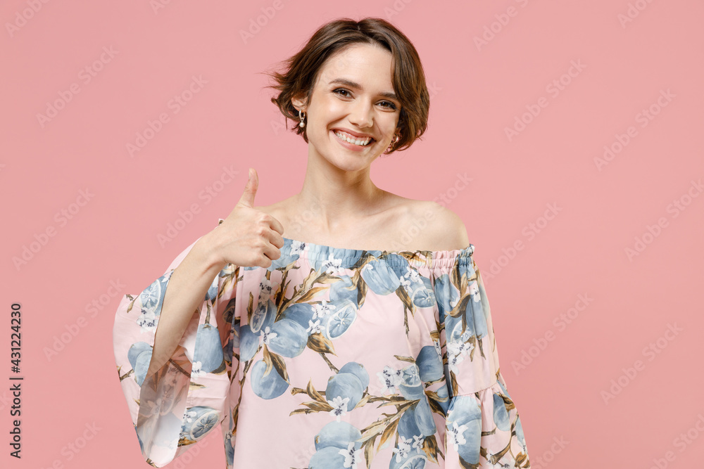 Young smiling happy stylish satisfied caucasian woman 20s with short hairdo wear trendy blouse show thumb up like gesture isolated on pastel pink background studio portrait. People lifestyle concept Young smiling happy stylish satisfied caucasian woman 20s with short hairdo wear trendy blouse show thumb up like gesture isolated on pastel pink background studio portrait. People lifestyle concept