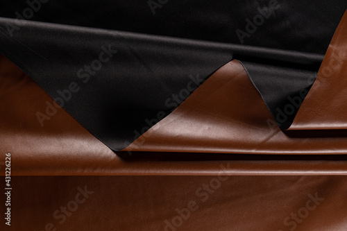 surface with folds of artificial leather for sewing clothes in bronze color